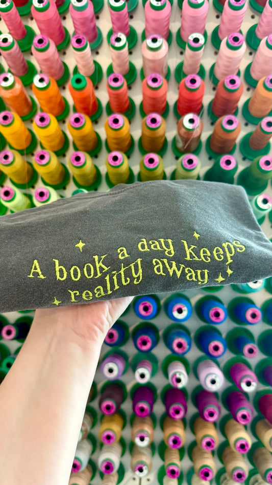 A Book a Day Keeps Reality Away Crop Tee